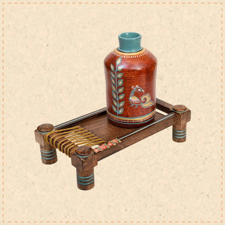 Rustic Red Madhubani Vase placed on Ethnic Charpai Stand (12.5x7x12.5)